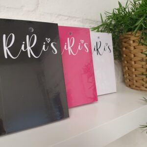RiRis clothing tags printed in black, pink and white